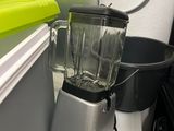 a blender sitting on a counter next to a container
