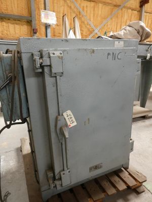 a metal box sitting on a pallet in a warehouse