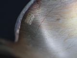 a close up of a spoon on a black surface