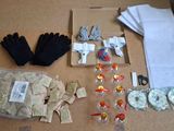 a table with many items on it including gloves, gloves, gloves, and other items