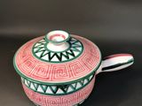a close up of a red and green bowl on a black surface