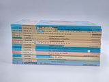 books stacked on top of each other on a white surface