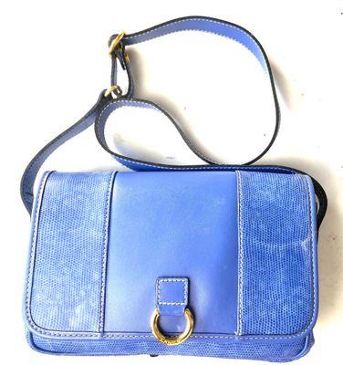 a blue purse with a gold ring on it
