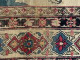 a close up of a very old rug on a table