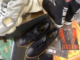 two pairs of shoes and a book on a table