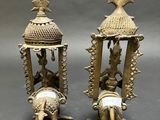 pair of antique brass figurines of a man and a woman on a horse