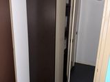 two closets in the hallway next to each other