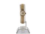 an image of a gold watch on a clear stand on a white background