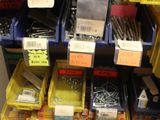 many bins of screws and screws on the shelf