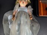 a doll that is sitting on a table next to a musical instrument