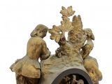 a clock that has a statue of a woman and children on it