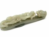 a jade carving of a dragon on a white background
