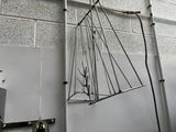 a metal object hanging from the ceiling of a building