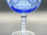 a blue glass bowl sitting on top of a table