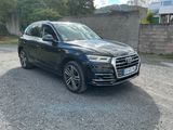 the black audi qx parked in a parking lot