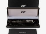 a close up of a pen in a black box with a white background