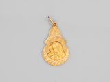 un pendentif en or sur lequel est représentée une femme