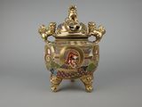 an image of a gold vase with a picture of a woman on it