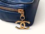 a blue purse with a gold chain hanging from it