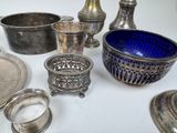a lot of silver and blue glass items on the table