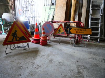 a lot of construction signs on the floor in the garage