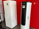 two refrigerators and a refrigerator freezer in a red room
