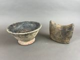 pair of old pottery bowls on stand on grey background