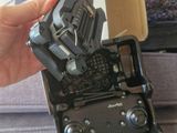 a person holding a remote control that is in a box
