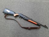 the rifle is laying on the floor next to a brown strap