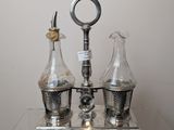 three glass vases on a table with a clock on it
