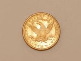 a close up of a gold coin with an eagle on it