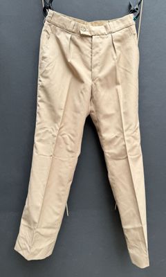 an image of a pair of beige pants hanging on a clothes line