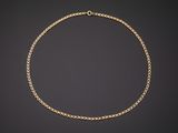 a gold chain necklace on a black background