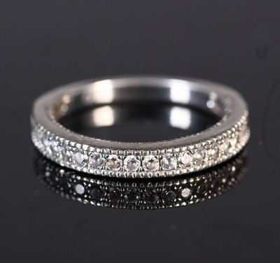 a close up of a diamond ring on a black surface