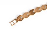 an image of a gold bracelet on a white background