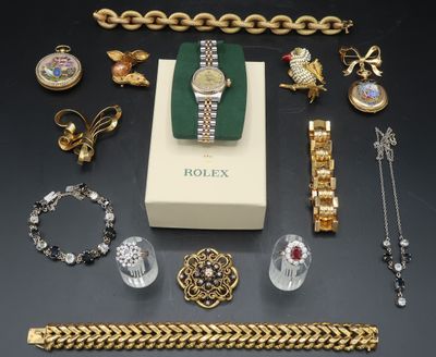 an assortment of jewellery including a watch, bracelets, and other items