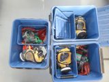 four blue bins filled with different types of toys