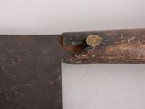 a large knife that is sitting on top of a piece of wood
