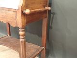a small wooden table with a mirror on top of it