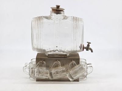 an old fashioned glass beverage dispenser with a faucet on it