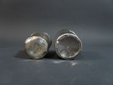 two salt and pepper shakers sitting on a table
