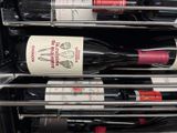 several bottles of wine are stacked on top of each other in a refrigerator