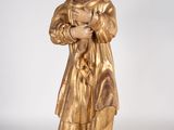 gold statue of a woman holding a baby in her arms