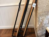 two wooden frames leaning against a wall next to a chair