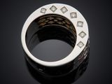 a close up of a ring with diamonds on a black surface