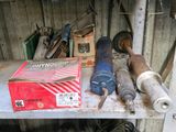 a metal shelf with tools on it in a garage