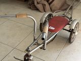a small child ' s tricycle that is sitting on the floor