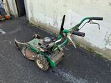 a small lawn mower that is sitting on the ground