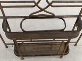 a metal shelf with a basket on top of it
