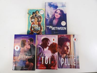 four books on the table that are on top of each other